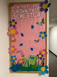 a bulletin board that says now have you grown this semester? with flowers and grass