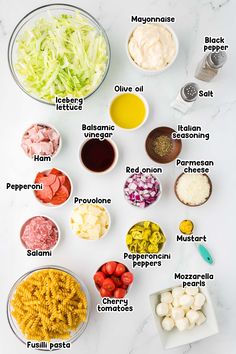 the ingredients to make this pasta salad are shown in bowls on a marble countertop