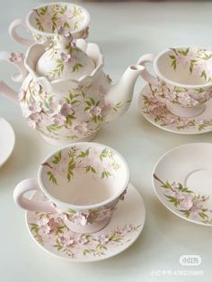 tea set with pink flowers and green leaves