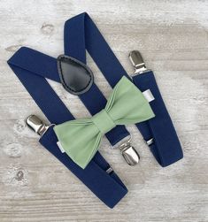 Your special guy will look so handsome when he shows up in his Sage bow tie , pocket square & Navy Blue suspenders! Great set for groomsman, best man or ring bearers - This bow tie & suspenders set is a great choice for family photos, wedding, ring bearer outfit, birthday celebration or any other special occasion.  Please  contact us about FREE COLOR SAMPLES ! Each bow tie comes pre-tied and made with adjustable strap . You can also write the note for your order if you need ALLIGATOR CLIP or BAR Dapper Suspenders For Wedding, Dapper Wedding Suspenders, Groom's Bow Tie With Suspenders, Adjustable Bow Tie For Groom, Adjustable Dapper Belts And Suspenders For Formal Wear, Navy Blue Pants Gold Suspenders Sage Green Bow Tie, Ring Bearer Navy, Ring Bearer Outfit Navy, Ring Bearer Outfit Suspenders Sage Green