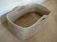 a basket sitting on the floor next to a window