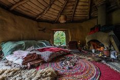 a room with a bed, rugs and other items on the floor in front of a window