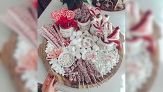 a table topped with lots of different types of candies and candy canes on top of each other