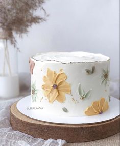 a white cake with yellow flowers on it