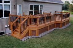 a wooden deck next to a gray house