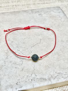 This beautiful handmade contemporary rakhi is made with genuine lava bead adorned with two gold beads.  This bracelet is adjustable and completely unisex, ideal for both adults and children. Not exactly what you're looking for?  I offer the largest range of beautiful contemporary rakhis, you can find them here:   https://www.etsy.com/ca/shop/LilyDailyBoutique?ref=seller-platform-mcnav§ion_id=38482903 ❤ BRACELET DETAIL: Genuine Lava Bead are known to have grounding properties which help the body Handmade Friendship Bracelets For Festivals As Gift, Adjustable Round Bracelets For Puja, Adjustable Bracelets For Puja, Spiritual Friendship Bracelets As Festival Gifts, Traditional Beaded Bracelets With Sliding Knot For Gift, Traditional Jewelry With Sliding Knot For Gifts, Traditional Sliding Knot Jewelry As Gift, Adjustable Bracelets For Festivals As Gift, Adjustable Bracelets As Gift For Festivals