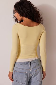 A soft and seamless essential, this go-to long sleeve features a square neckline and formfitting silhouette. **Fit:** Formfitting, fitted sleeves, slightly cropped **Features:** Soft fabrication, seamless design, square neckline **Why We | Clean Lines Long Sleeve by Intimately at Free People in Yellow, Size: XS/S Free People Basics, Free People Shirts, Light Yellow Top, Yellow Long Sleeve Shirt, Conan Grey, Yellow Clothes, Yellow Tops, Free People Long Sleeve, Yellow Long Sleeve