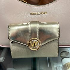 Michael Kors Carmen Medium Logo And Faux Leather Wallet Pale Gold Nwt All Our Listed Item Are Authentic, Brand New Condition With Tag Size: Approximately 4.89 Wide X 3.67 Long X 1.63 Thick (Inch) Weight: Approximately 120 G Material: Leather Opening And Closing Type: Snap Internal Style: Zipper Coin Purse X 1, Wallet X 1, Open Pocket X 2, Card Pocket X 6 External Style: 1 Open Pocket Michael Kors Carmen 35f3gnmf8m Pale Gold Md Flap Blfld Wallet Michael Kors Travel Wallets With Gold-tone Hardware, Travel Wallets With Gold-tone Hardware, Gold Leather Bifold Bag, Gold Bifold Leather Bag, Gold Bifold Coin Purse, Michael Kors Gold Wallet For Everyday Use, Gold Michael Kors Wallet For Everyday Use, Luxury Michael Kors Bifold Bags, Compact Gold Bag With Card Slots