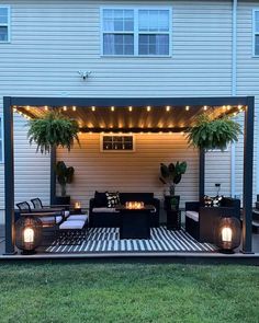 an outdoor living area with patio furniture and lights