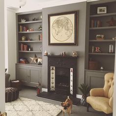 a dog is standing in the middle of a living room with bookshelves and a fireplace