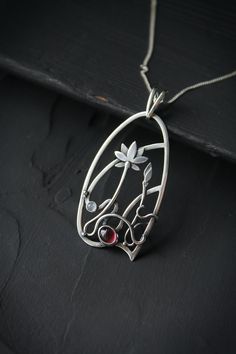 ITEM DESCRIPTION: The size H 4 cm x W 3 cm (1 3/4 x 1 inch). Weight - 6 g. You can buy it with the chain or without. The most delicate flower of the lotus can make someone very happy. I made this floral jewelry of sterling silver, rhodolite garnet, and moonstone. This is a true work of art. It will emphasize your exquisite taste and status, and will also bring a lot of compliments. Lotus flower earrings https://www.etsy.com/listing/676137548/lotus-flower-earrings-sterling-silver?ref=shop_home_ac Soldered Flower Pendant Jewelry For Gift, Soldered Flower Pendant Jewelry Gift, Delicate Wire Wrapped Pendant Necklace, Wire Wrapped Flower Pendant Jewelry Gift, Silver Wire Wrapped Flower Jewelry, Hand Forged Flower Pendant Necklace As Gift, Art Nouveau Pendant Necklaces For Jewelry Making, Flower Shaped Hand Forged Jewelry Gift, Hand Forged Flower Jewelry Gift