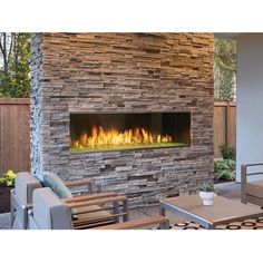 an outdoor fireplace is shown with chairs and tables