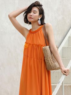 Calf-length, A-line halterneck seaside dress in polyester. Round neck and ruched detail at midsection. Lined.- Maxi- 3/4 sleeve- A-line- Halterneck Round Neck, A Line, Orange