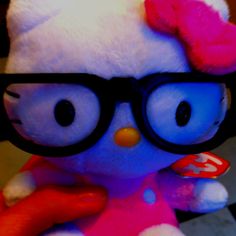 a close up of a stuffed animal wearing glasses