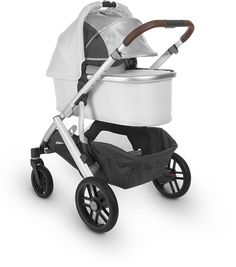 a white stroller with a wooden handle