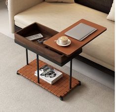 a coffee table with a tray on it and a laptop sitting on top of it