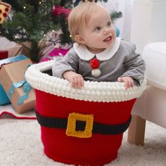 a baby is sitting in a christmas basket