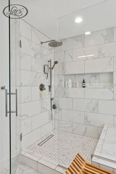 a walk in shower sitting next to a wooden bench