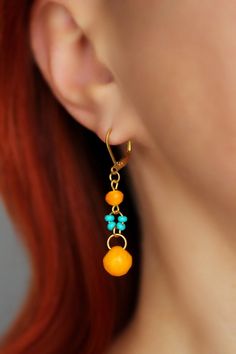 Beautiful feminine summer earrings with bright yellow orange fruit czech glass beads (9x9 mm), tiny turquoise color glass seed beads, small bright yellow faceted beads and gold tone stainless steel lever back earring hooks.  Earring hooks are from lead free & nickel free metal. Perfect jewlery for everyday wear or a great gift! The total length of earrings is about 50 mm including earring hooks. Other earrings of my shop you can see here:  https://www.etsy.com/shop/NaTavelli?section_id=13757927 Fruit Beads, Feminine Summer, Beaded Earring, Summer Earrings, Yellow Gold Earrings, Beads Earrings, Orange Fruit, Summer Earring, Earrings Unique