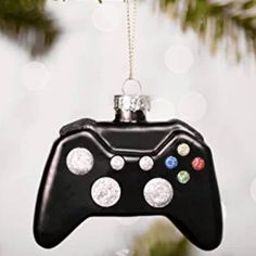 a video game controller ornament hanging from a christmas tree