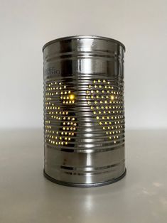 a tin can with some yellow dots on it