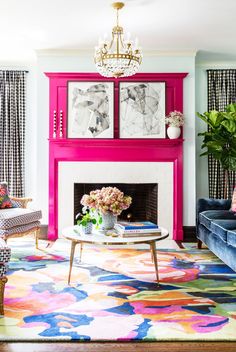 a living room with colorful furniture and paintings on the fireplace mantels in front of it