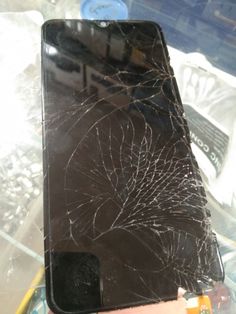 a broken cell phone sitting on top of a table