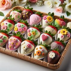 a basket filled with lots of different types of chocolate covered strawberries on top of a table