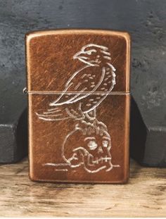 a brown lighter with a bird on it