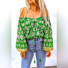 Bohemian Printed Tassel Tie Blouse! Designed With A Free-Spirited, Fun Touch, This Blouse Is Sure To Make An Impression Anywhere. It Features An Absolutely Dazzling Off-Shoulder Neckline, With A Drawstring Closure For That Perfect Fit. Long Balloon Sleeves Create An Elegant Silhouette, And The Floral Pattern Is Oh-So Chic. Add A Touch Of Boho Flair To Your Everyday Wardrobe With This Beautiful Boho Blouse You Won't Regret It! Pet Free/Smoke Free Home. Long Sleeve Fringe Tops For Summer, Long Sleeve Fringe Top For Vacation, Bohemian Cotton Blouse With Back Tassel Tie-up, Green Boho Print Summer Blouse, Long Sleeve Tassel Tops For Vacation, Green Boho Print Vacation Blouse, Green Boho Print Blouse For Vacation, Green Boho Print Blouse For Beach, Green Boho Print Beach Blouse