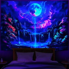 a bed with a large painting on the wall above it that has a waterfall at night