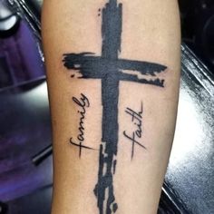 a cross tattoo on the arm with words written in black ink and an inscription that reads,