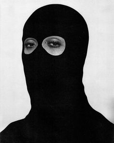 a person wearing a black mask with two eyes