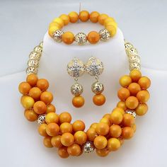 Enhance your bridal look with this classic Nigerian Wedding Bridal Jewelry. The African crystal beads jewelry set adds a touch of elegance and cultural significance to your wedding ensemble, creating a timeless and beautiful look. Elegant Yellow Jewelry Sets For Weddings, Elegant Yellow Jewelry For Marriage, Traditional Gold Beads For Marriage, Yellow Crystal Necklace For Weddings, Formal Yellow Jewelry With Round Beads, Traditional Beaded Jewelry Sets For Marriage, Elegant Orange Polished Beads Jewelry, Elegant Orange Jewelry With Polished Beads, Gold Beaded Bridal Set For Wedding