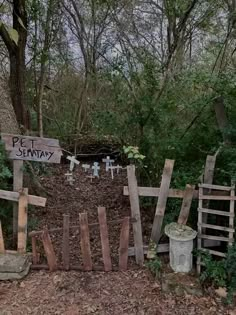 a fence made out of pallets and wood with the words pet sanctuary written on it