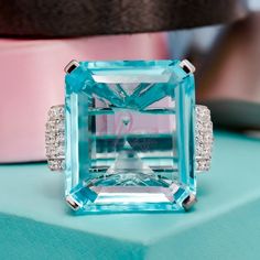 "Specification:- Stone Details :- *Diamond Material : Cubic Zirconia *Center Diamond Shape : Emerald Cut *Center Diamond Dimension : 35*30 MM *Side Diamond Dimension : 2.20 MM *Side Diamond Weight : 1.32 CT *Diamond Color : Aquablue, White *Clarity : VVS *Making Process: Handmade by our Experienced Staff. *Stamp: Our All Rings Stamped According to metal Purity (925 SIL/10K/14K/18K). Customization:- *Buyer can Request change of rhodium color in 925 Silver Jewelry (No additional Charge). *In Gold Elegant Turquoise Diamond Anniversary Ring, Formal Blue Topaz Diamond Ring In Diamond White, Formal Aquamarine Ring With Diamond Accents, Dazzling Topaz Ring With Cubic Zirconia Accent Stones, Turquoise Topaz Diamond Ring For Anniversary, Luxury Turquoise Topaz Ring For Anniversary, Turquoise Cubic Zirconia Jewelry For Anniversary, Anniversary Turquoise Topaz Ring With Diamond, Dazzling Aquamarine Jewelry With Gemstones