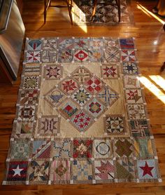 an old quilt is laying on the floor