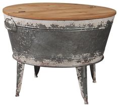 an old metal tub with a wooden table in the center and legs on it, isolated against a white background