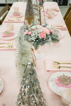 the table is set with pink and silver decorations