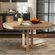 a bowl of oranges sitting on top of a wooden table in a living room