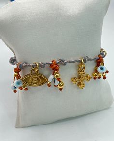 Cotton rope bracelet with all the protection against bad vibes. Its decorated with gold plated beads and charms that elevated its style.. Bad Vibes, Cross Bracelet, Cotton Rope, Charm Bracelets, Evil Eye, Rope Bracelet, Halloween Shopping, Jewelry Bracelets, Charm Bracelet