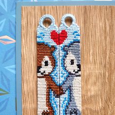 the beaded bookmark has two scissors on it's side, and is decorated with cartoon characters