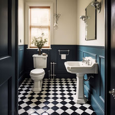 a bathroom with black and white checkered flooring, toilet, sink and mirror