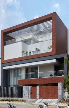 two mopeds parked in front of a modern house