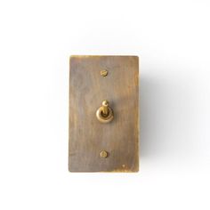 an old light switch with two knobs on the front and one in the back