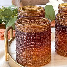 three brown glass jars sitting on top of a tray