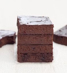 chocolate brownies stacked on top of each other with one piece cut out to show the inside