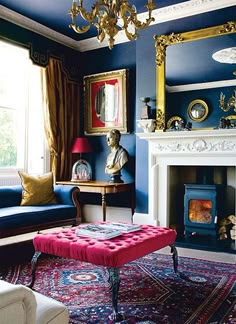 a living room filled with furniture and a fire place in front of a mirror on the wall