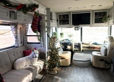 a dog is sitting on the couch in front of an rv decorated with christmas decorations