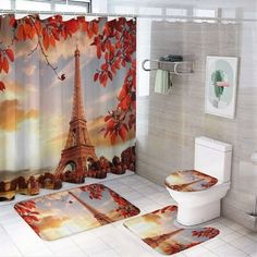 a bathroom with a shower curtain, toilet and rugs in the shape of the eiffel tower